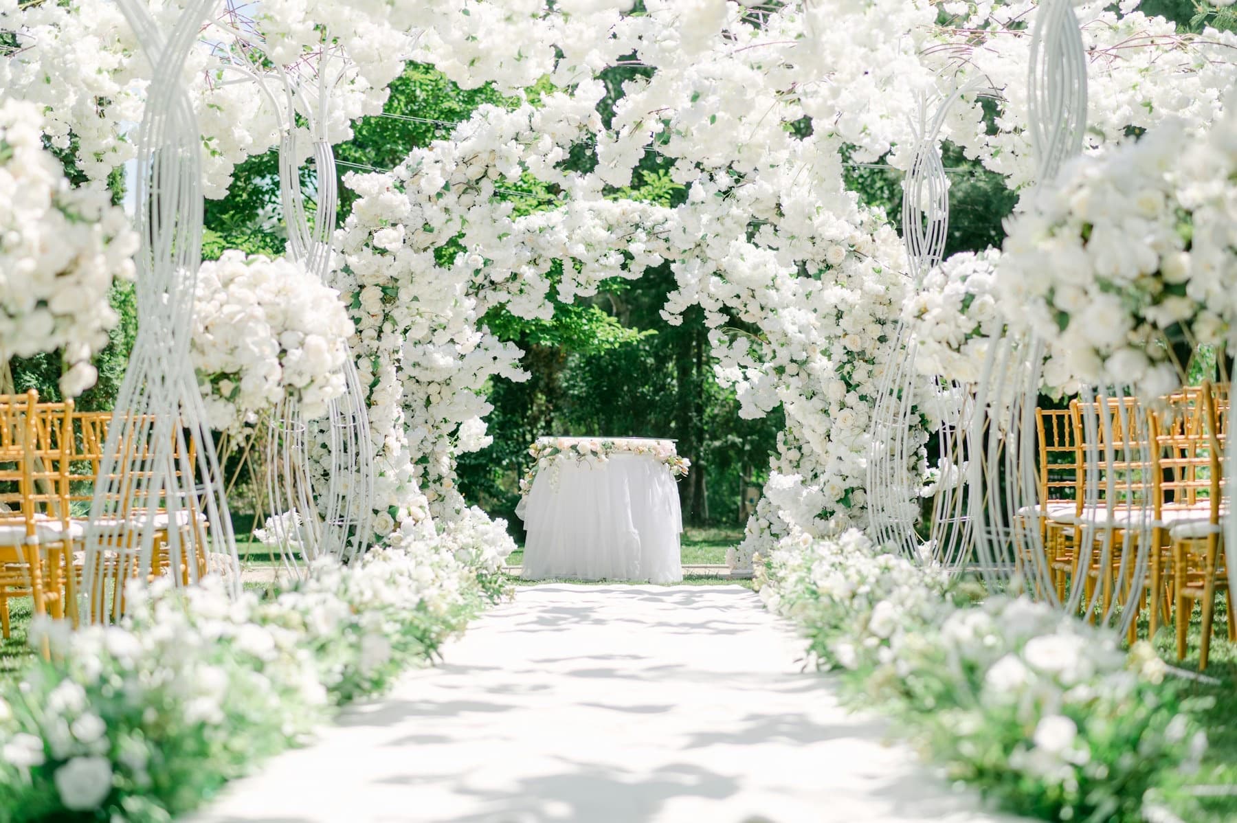 An outdoor ceremony space prepared with flowers and seating
